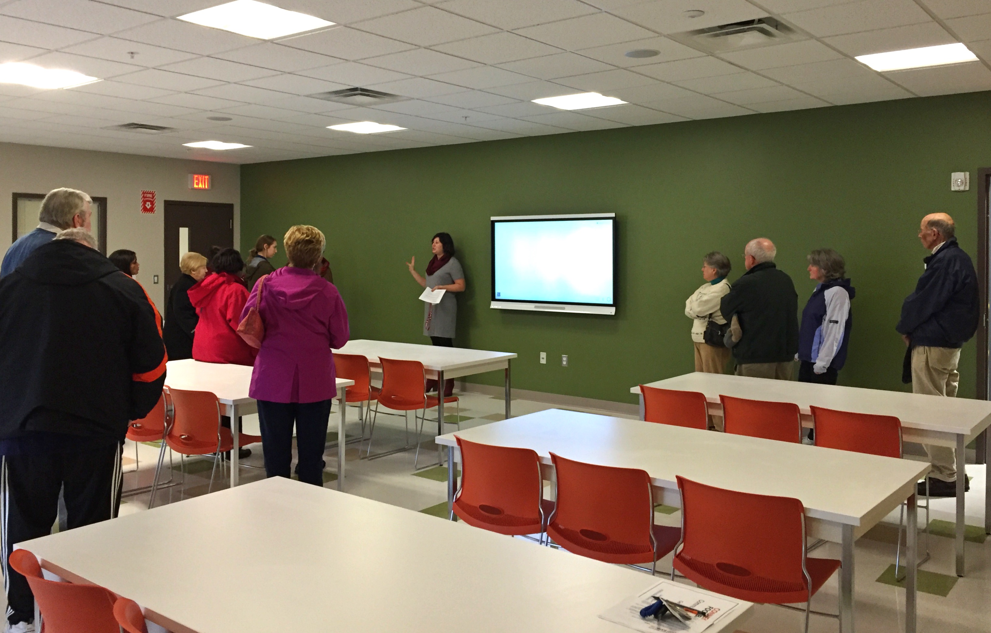 Connecticut Food Bank Director of Community Engagement shows visiting member programs the features of the training room at our new distribution center. The room is used for volunteer orientation and training and is available for member programs and community groups to use as well.