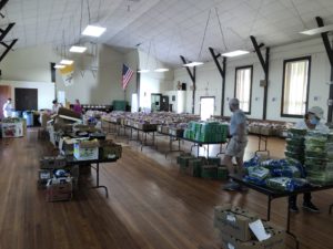 Volunteers package food from Connecticut Food Bank in boxes for distribution at a Mobile Pantry.